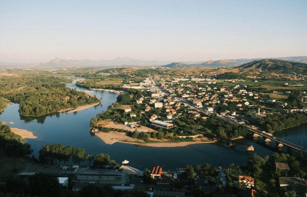 Devoll Valley Albania with mountains, farmland, and the Devoll River’s crystal-clear waters, offering rural countryside views and scenic nature near Korçë