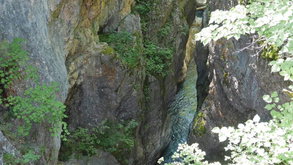 Grunas Waterfall Theth with canyon views along a hiking trail