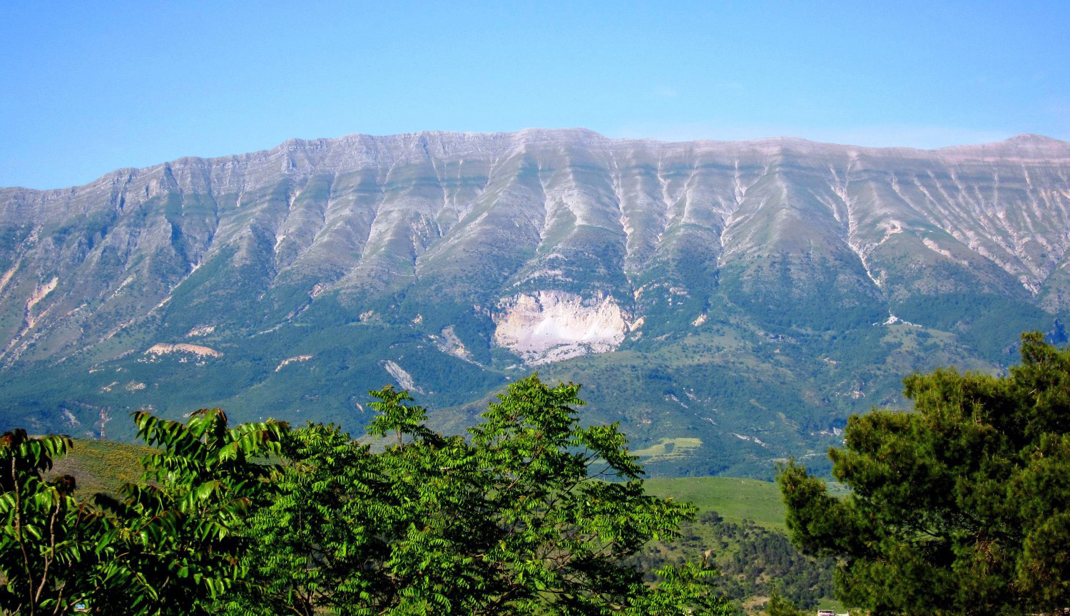Mali i Gjerë ridge above Gjirokastër — the wide mountain sheltering the Blue Eye spring
